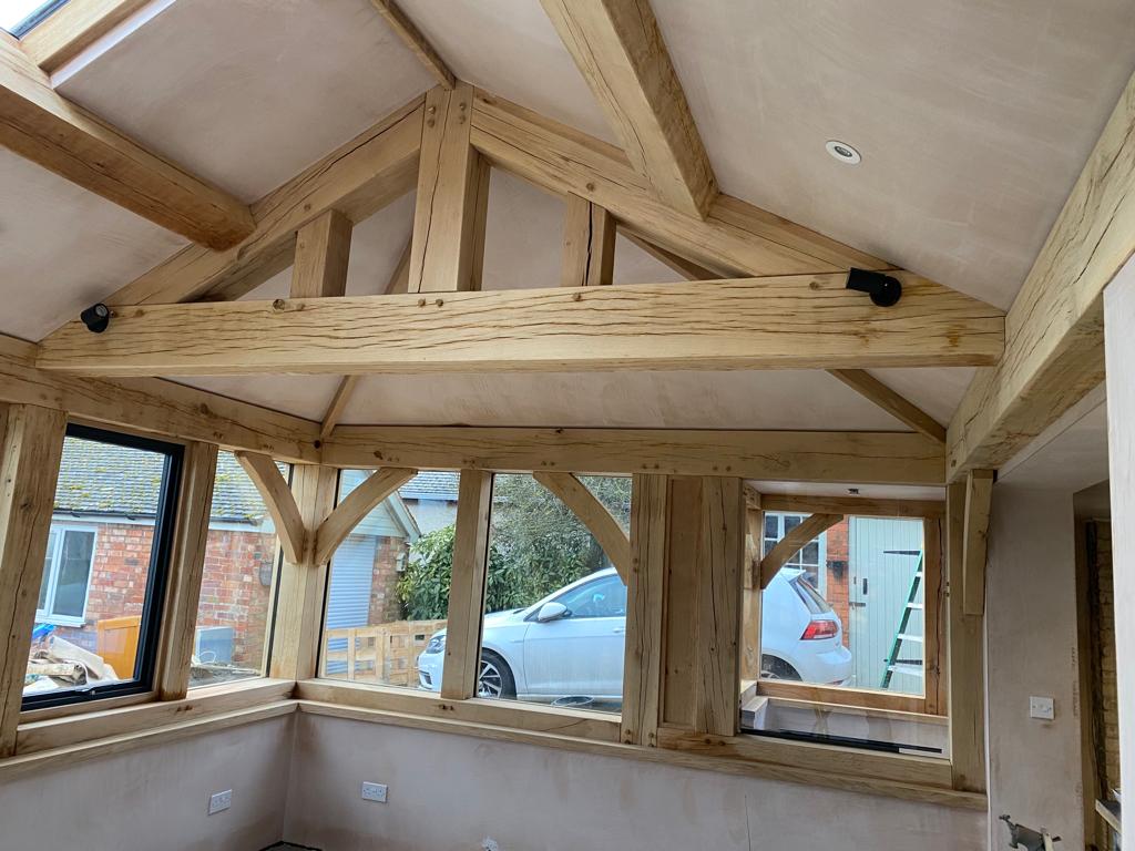 Plastered single story room which was overboarded and skimmed in Leicester with wooden beams