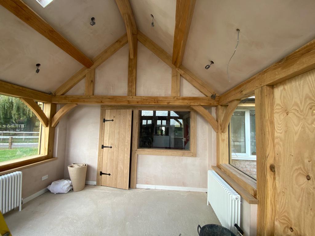 Plastered barn in Market Harborough, Leicestershire with wooden beams and door