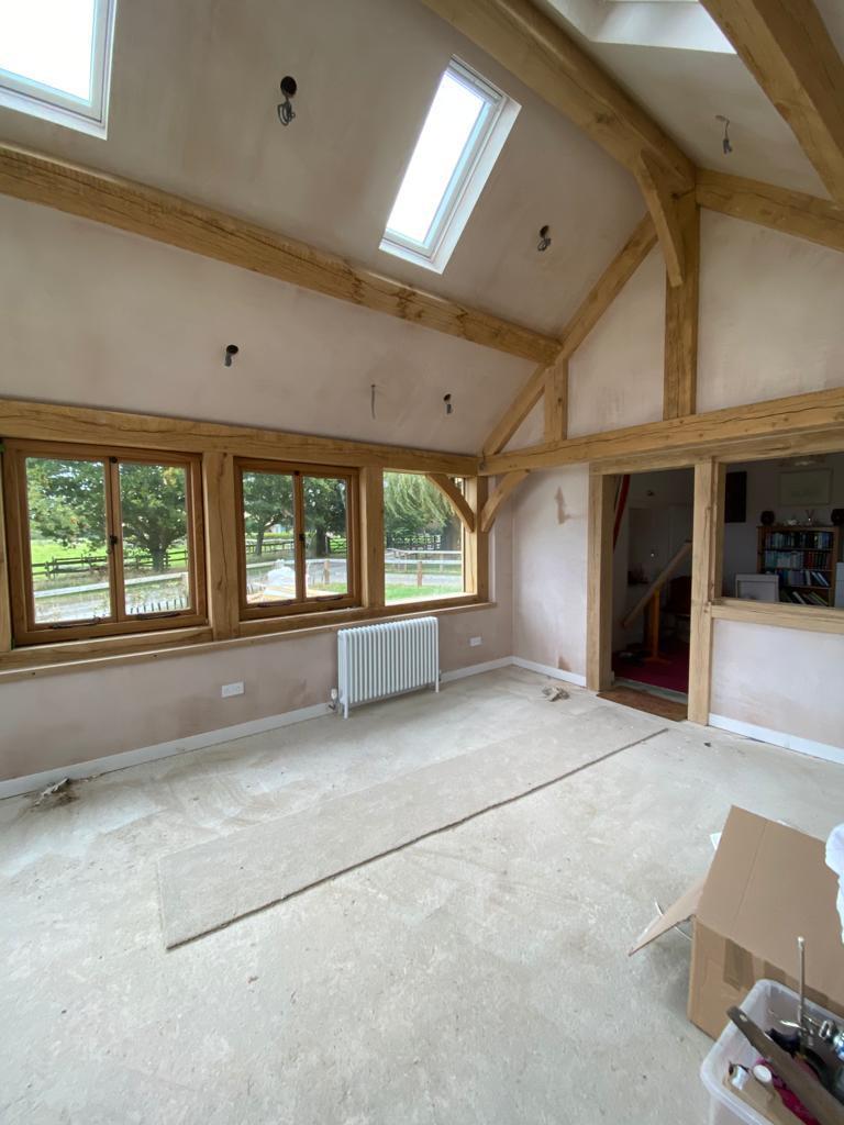 Plastered barn in Market Harborough, Leicestershire with wooden beams and windows