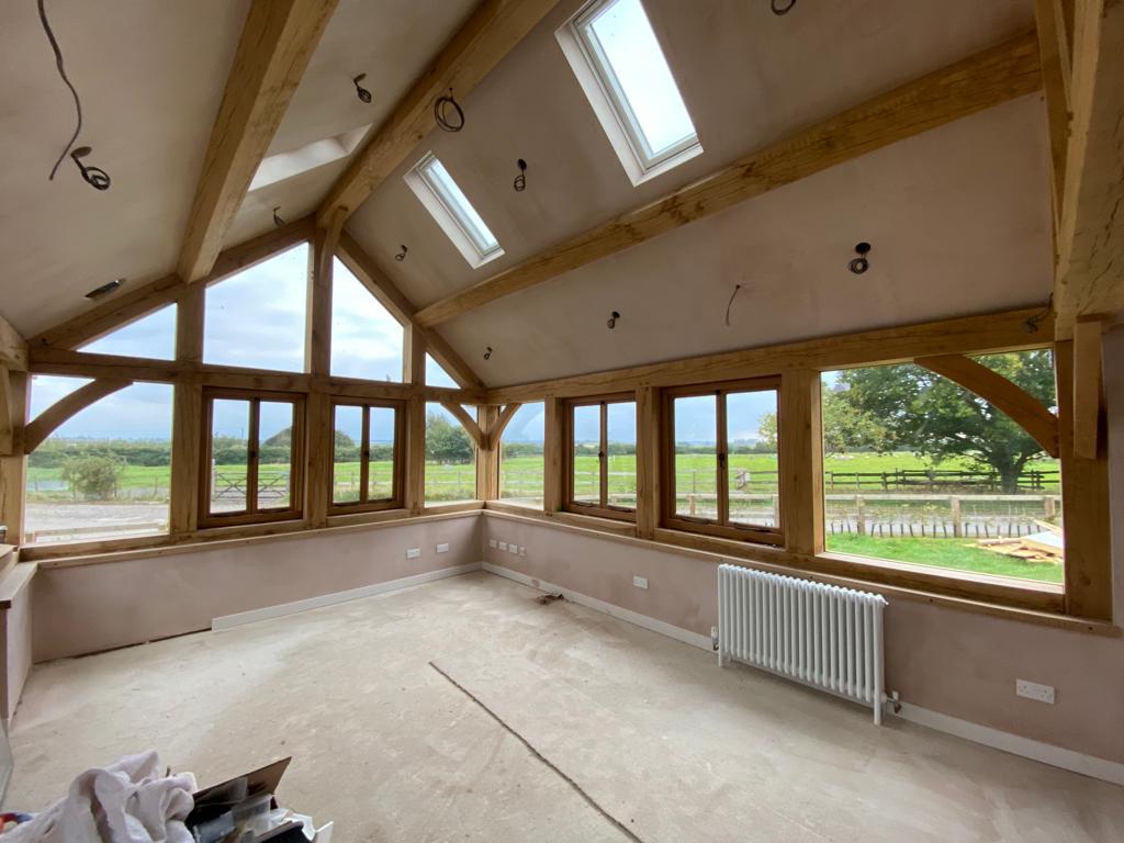 Plastered barn in Market Harborough, Leicestershire with wooden beams and large front facing windows