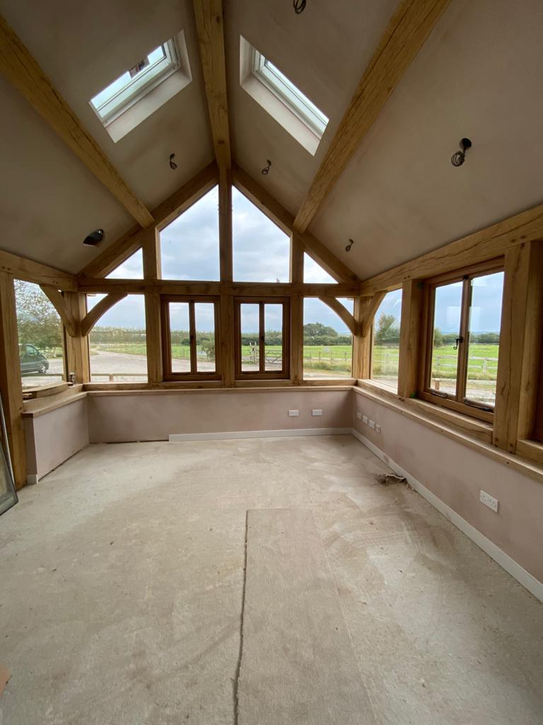 Plastered barn in Market Harborough, Leicestershire with wooden beams and large front facing windows